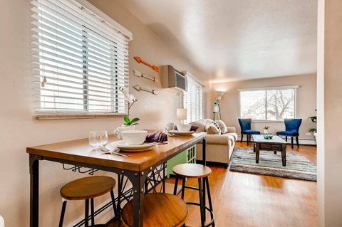 a kitchen with a bar and a living room with a couch